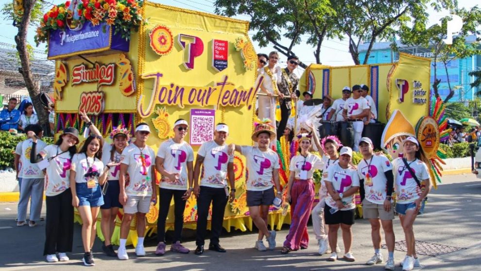 A group of people standing in front of a yellow float